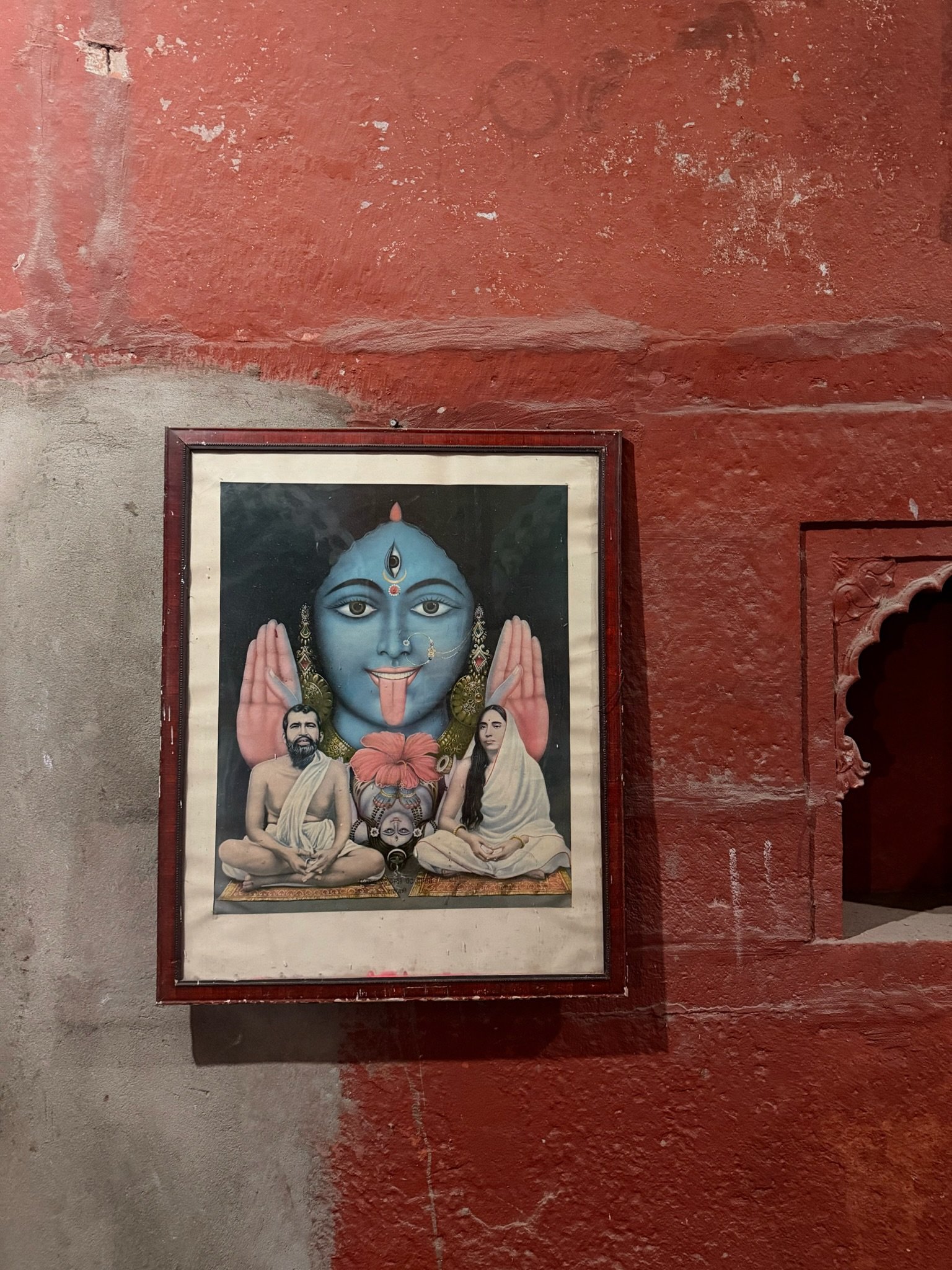 Image of Kali within a red temple wall